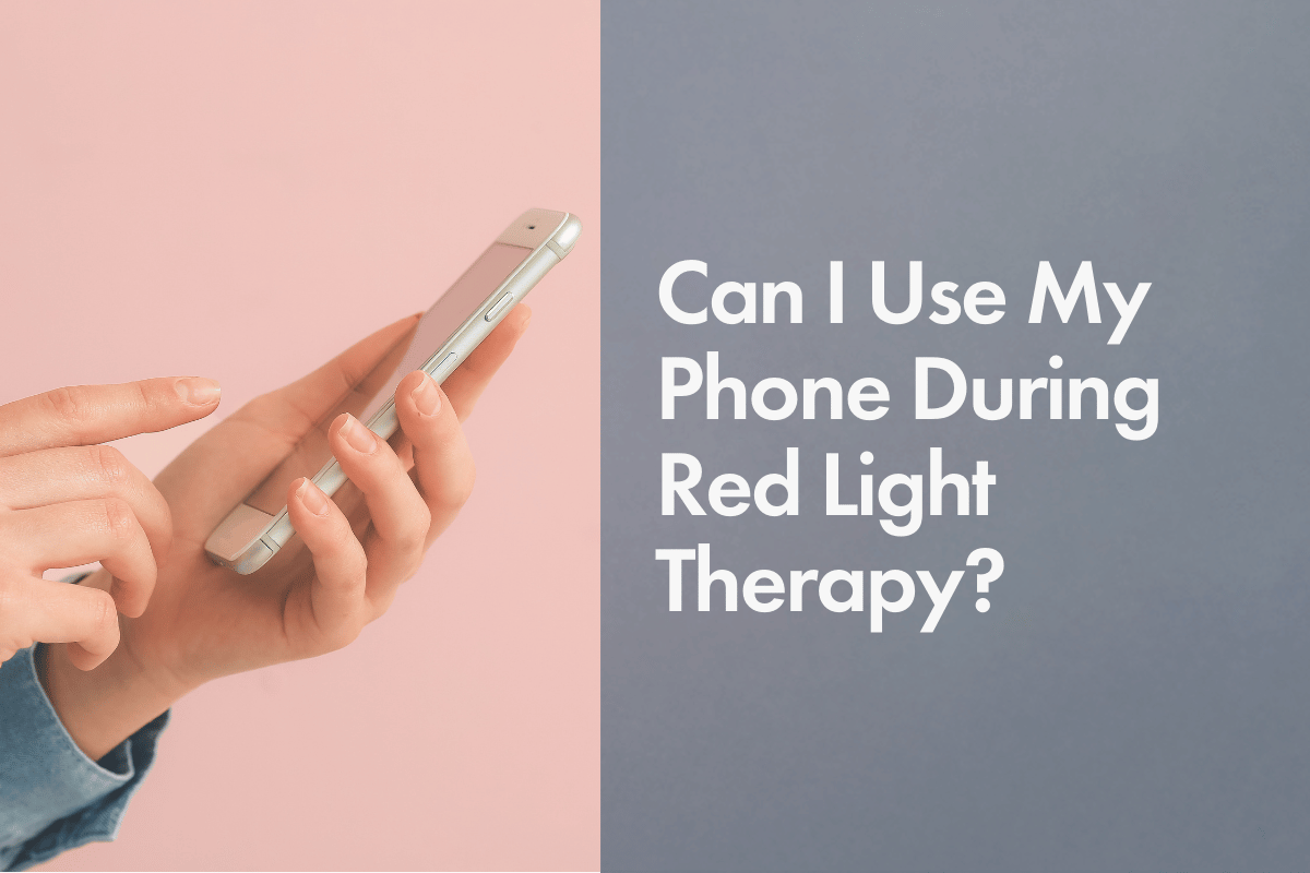An image of a person holding a smartphone in their right hand, with their left index finger tapping the screen. The background consists of a soft pink on the left side and a cool gray on the right. The text on the right side reads, "Can I Use My Phone During Red Light Therapy?" in large, white font.